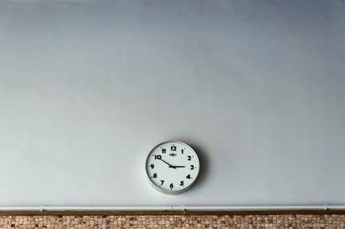 Clock hanging on classroom wall